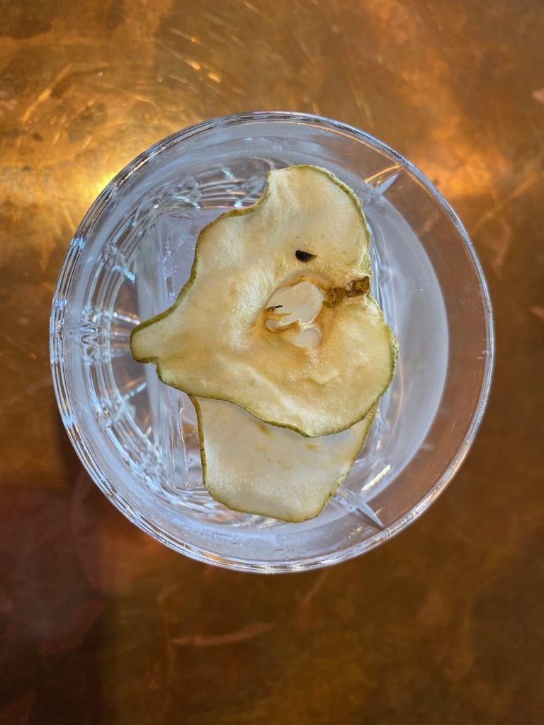 Der Paere-Cocktail aufgegossen in einem Glas. Als Topping getrocknete Birne.