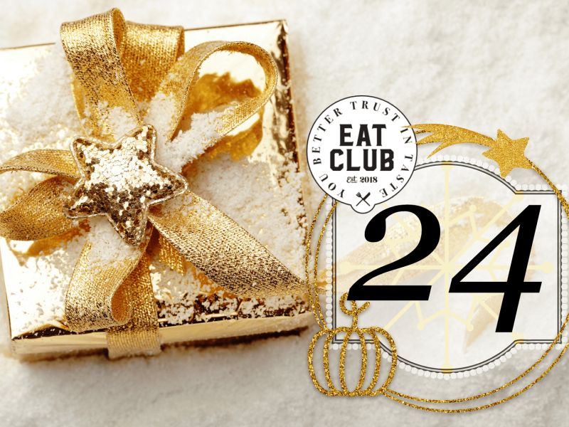Ein gold eingepacktes Geschenkt auf hellem Untergrund, mit Symbolbild und EAT CLUB Logo.