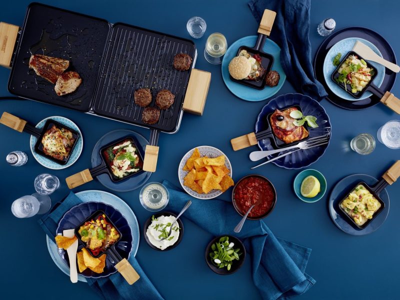 Verschiedene kreative Raclette-Ideen auf blauem Untergrund
